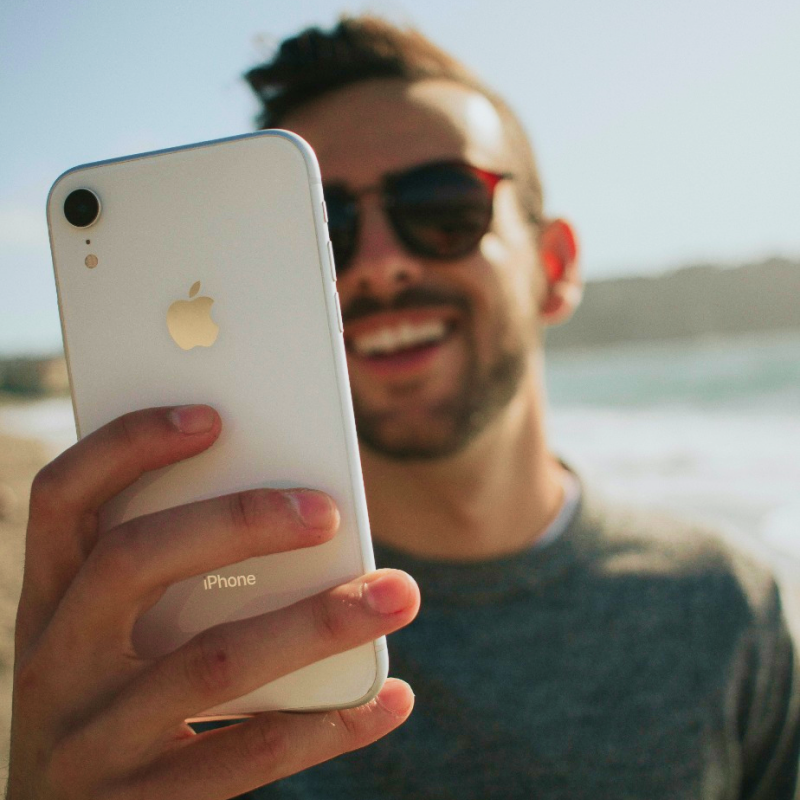 man-on-beach-buying-digital-vouchers-in-the-app